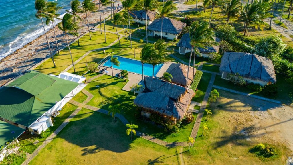 The Art of Drawing Readers In: Your attractive post title goes here Stunning aerial view of a tropical resort in Bacong, Philippines, showcasing palm trees, beach, and swimming pool.
