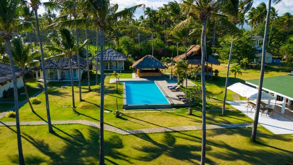 Crafting Captivating Headlines: Your awesome post title goes here Stunning aerial view of a tropical resort with a pool and lush greenery in Bacong, Central Visayas.